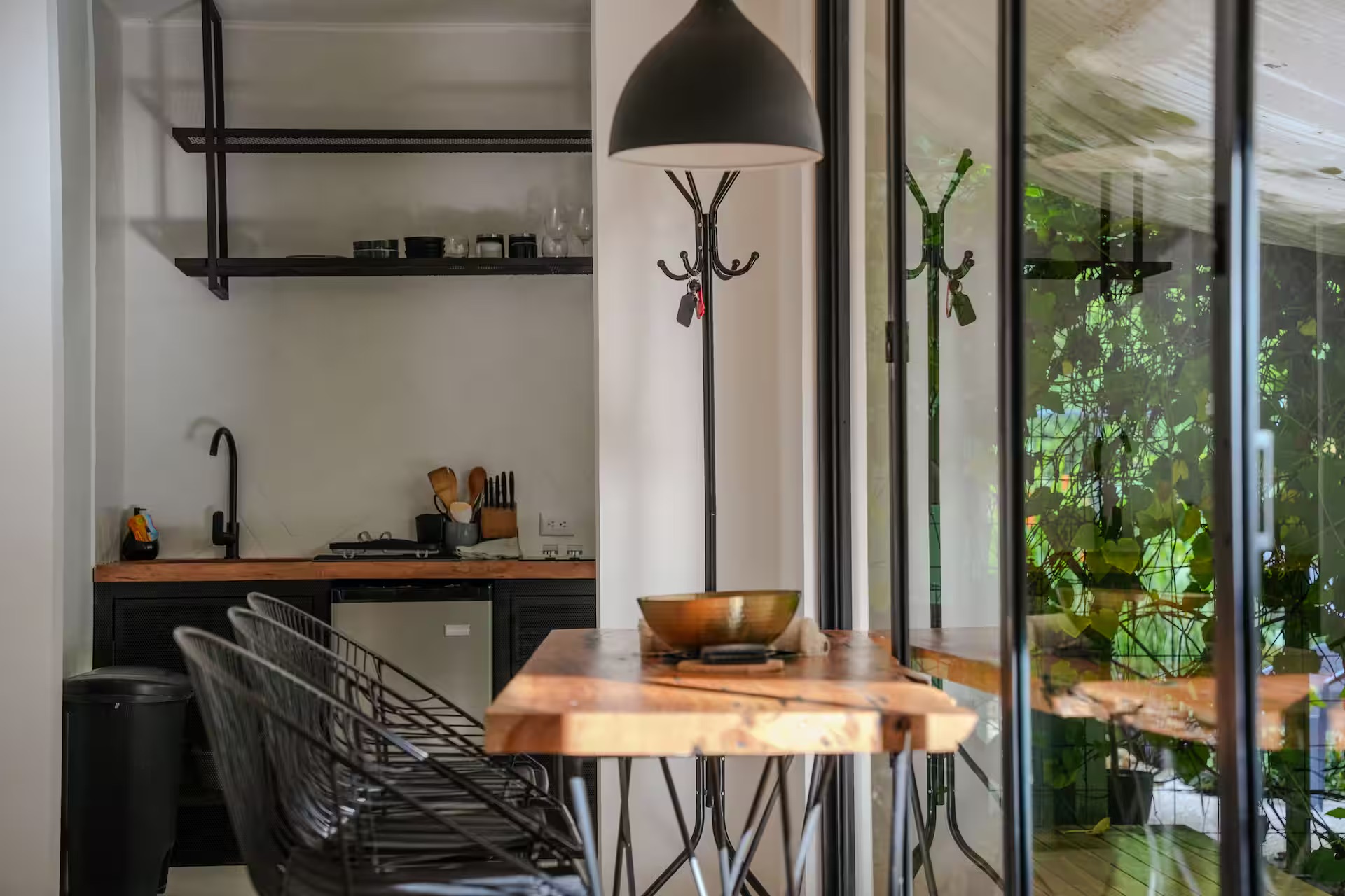 Kitchen and dining area with coat rack and live-edge table
