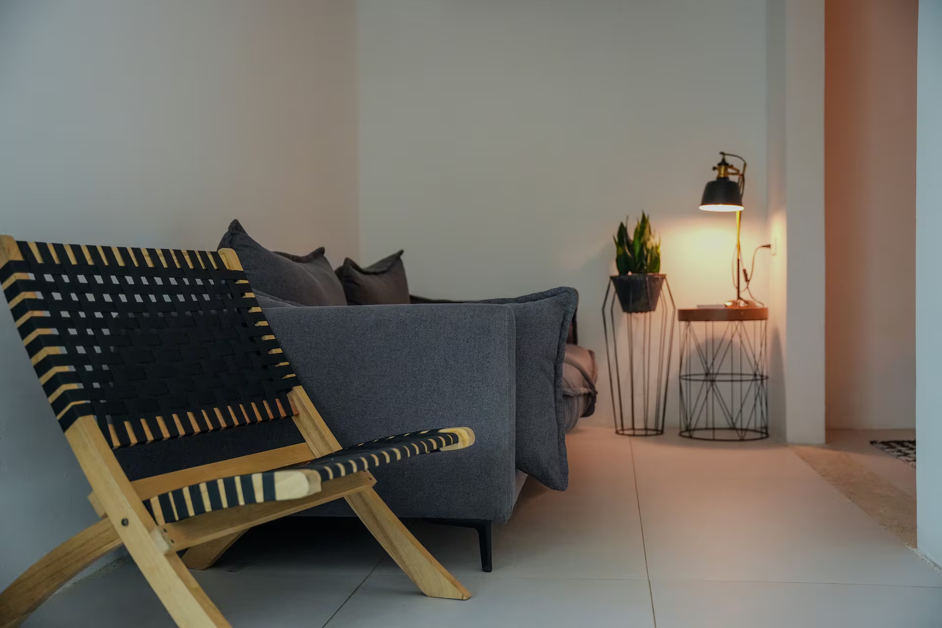 Woven lounge chair with sofa and warm floor lamp